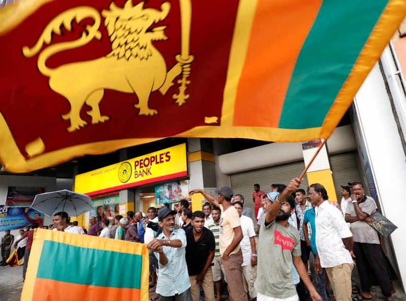 People celebrate after the voting ended during the presidential election day in Colombo