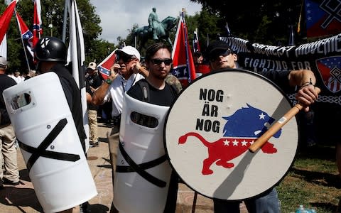 White supremacists stand behind their shields at a rally in Charlottesville, Virginia, U.S., August 12, 2017 - Credit: Reuters