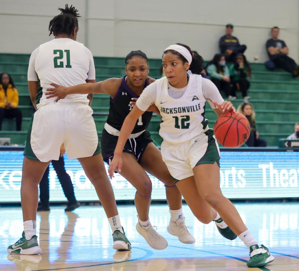 Jacksonville University's Jalisa Dunlap (12) goes around a screen set by teammate Shynia Jackson (21) during last week's victory over Lipscomb.