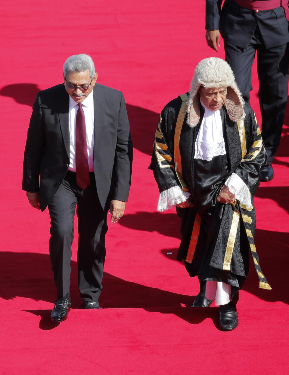 Sri Lankan president Gotabaya Rajapaksa, left, walks with the speaker Karu Jayasuriya on a rd carpet upon his arrival at the parliamentary complex to address the ceremonial inauguration of the session in Colombo, Sri Lanka, Friday, Jan. 3, 2020. (AP Photo/Eranga Jayawardena)