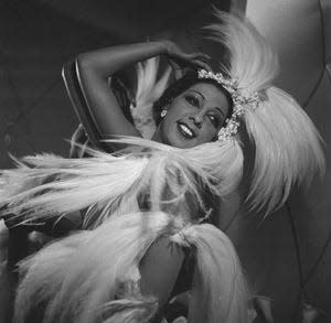 Josephine Baker black and white portrait posing in cabaret feathers, jeweled tiara