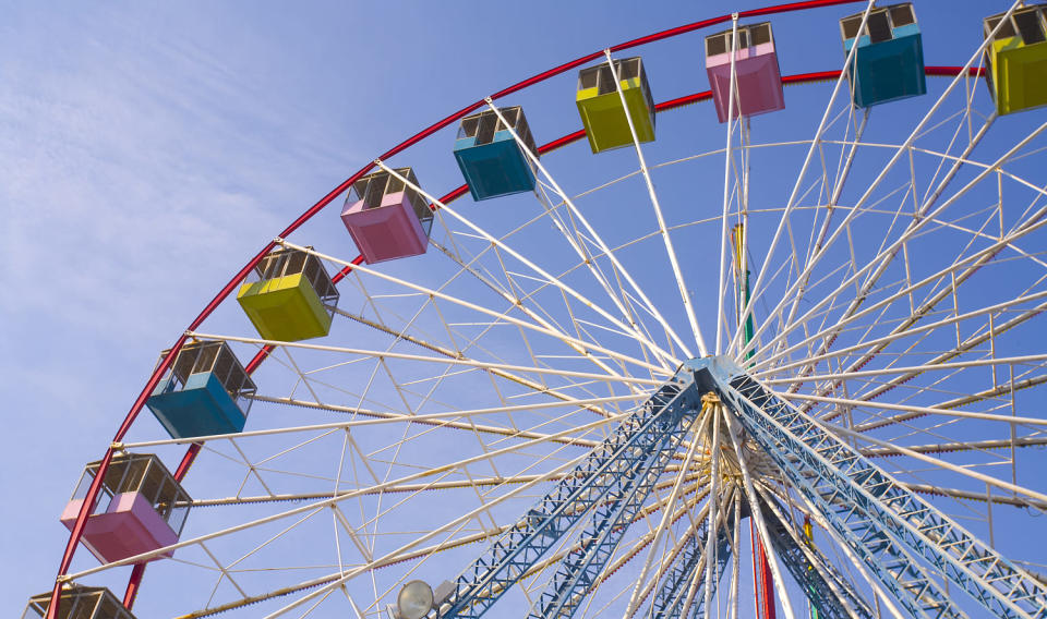 Picture of a colorful Ferris wheel in clear sky (Phaucet / Getty Images stock)