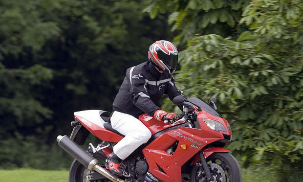 Prince William in motorbike gear riding a Daytona