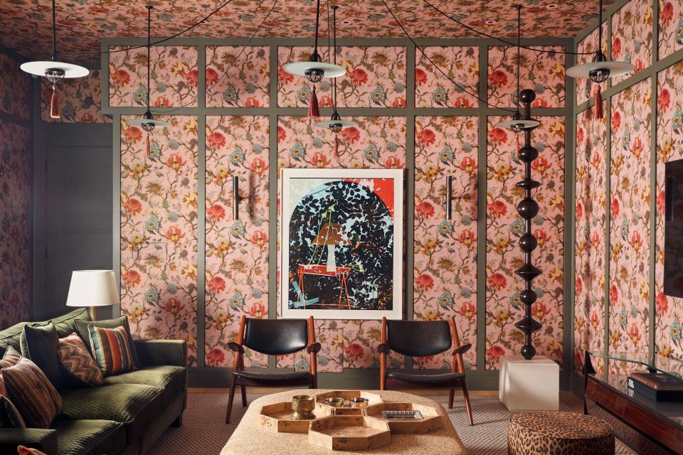 A printed linen by House of Hackney panels the cinema room. Bespoke sofa in a Schumacher velvet. Vintage Hans Wegner armchairs. Pendant lights by Lutyens Furniture & Lighting. Totem pole by Bryan O’Sullivan Studio. On walls, Paint & Paper Library paint.