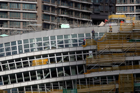 Laborers work on West Kowloon Terminus, under construction for the Guangzhou-Shenzhen-Hong Kong Express Rail Link, in Hong Kong, China July 21, 2017. REUTERS/Bobby Yip