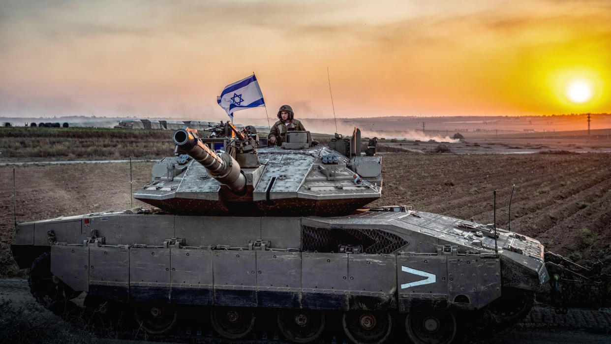  An Israeli soldier on a tank is seen near the Israel-Gaza border. 