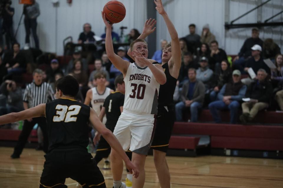 Kaden Clark (30) goes up for a shot over Faulkton's Layne Cotton inside the Aberdeen Christian School. Clark finished with eight points for the Knights.