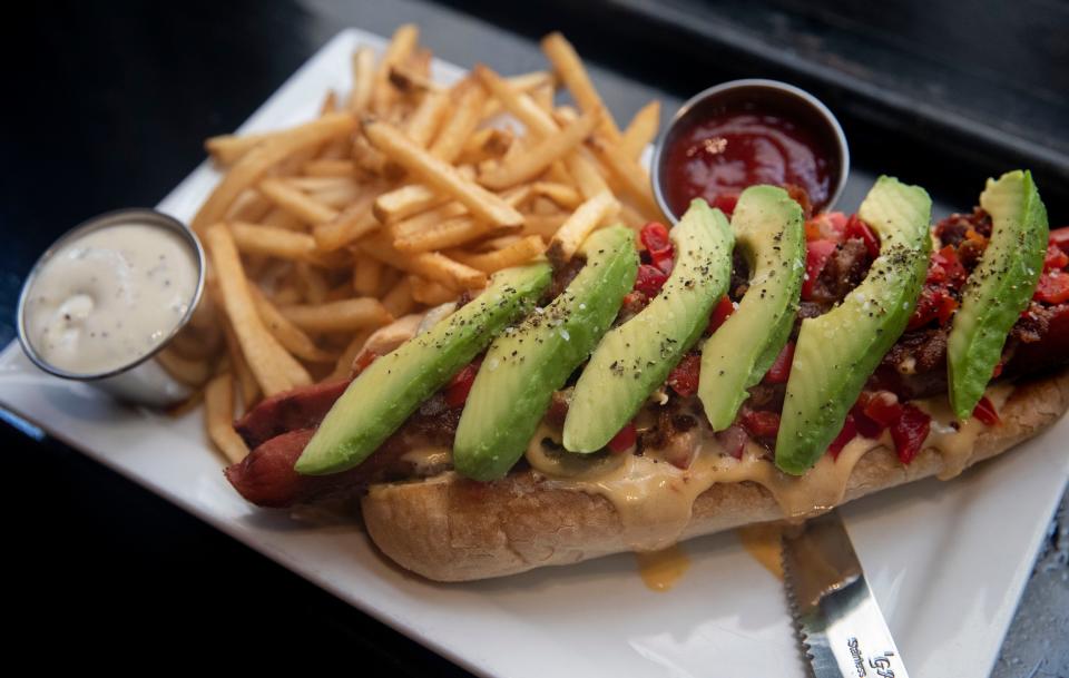 The Daily Special Dog features bacon, avocado, red peppers and jalapeño cheese sauce Wednesday, July 6, at Bardog Tavern in Memphis.