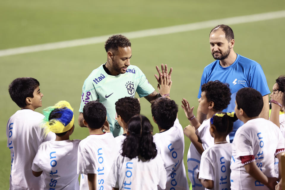 Neymar (pictured) greets youth players.