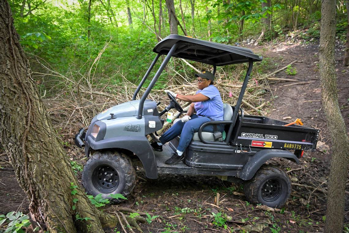 The Rev. Stacy Evans navigates difficult and slippery terrain on an all-terrain vehicle during a volunteer cleanup at the Quindaro Ruins.