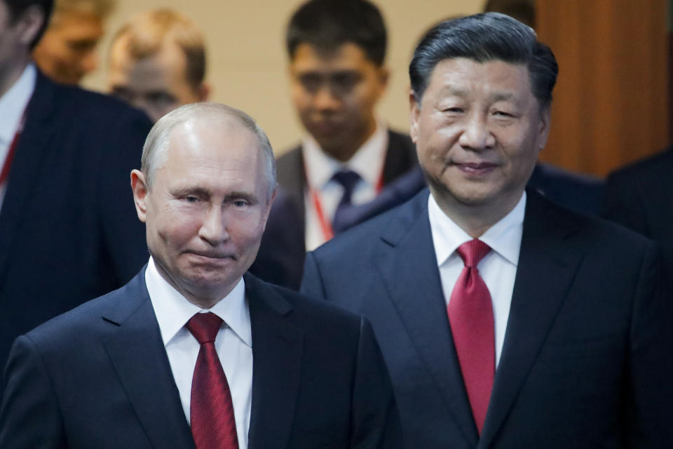 Russian President Vladimir, left, and Chinese President Xi Jinping arrive to attend a plenary session at the St. Petersburg International Economic Forum in St. Petersburg, Russia, Friday, June 7, 2019. (AP Photo/Dmitri Lovetsky)