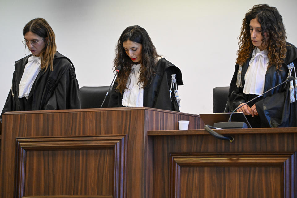 President of the court judge Brigida Cavasino, center, flanked by judges Claudia Caputo, left, and Germana Radice reads the verdicts of a maxi-trial of hundreds of people accused of membership in Italy's 'ndrangheta organized crime syndicate, one of the world's most powerful, extensive and wealthy drug-trafficking groups, in Lamezia Terme, southern Italy, Monday, Nov. 20, 2023. Verdicts are expected Monday for the trial that started almost three years ago in the southern Calabria region, where the mob organization was originally based. (AP Photo/Valeria Ferraro)