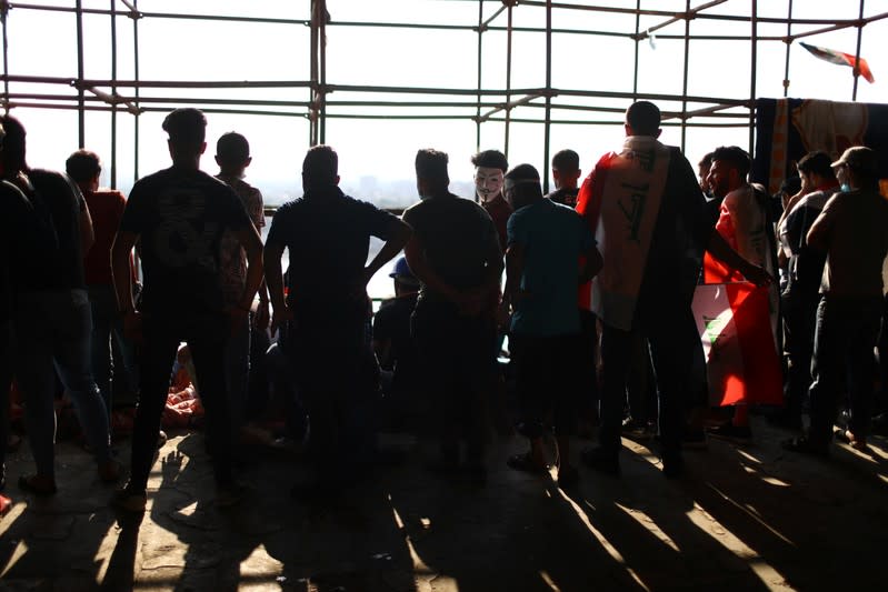 Iraqi demonstrators are seen inside the high-rise building, called by Iraqi the Turkish Restaurant Building, during anti-government protests in Baghdad