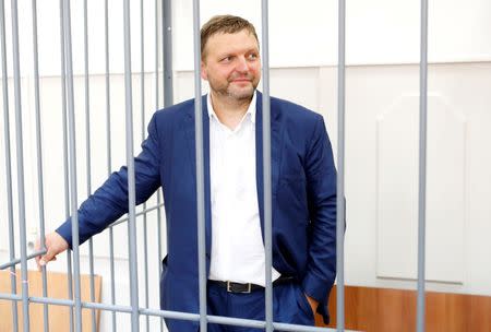 Governor of Kirov region Nikita Belykh, who is accused by the Investigative Committee of taking a bribe, stands inside a defendants' cage during a hearing at the Basmanny district court in Moscow, Russia, June 25, 2016. REUTERS/Maxim Zmeyev