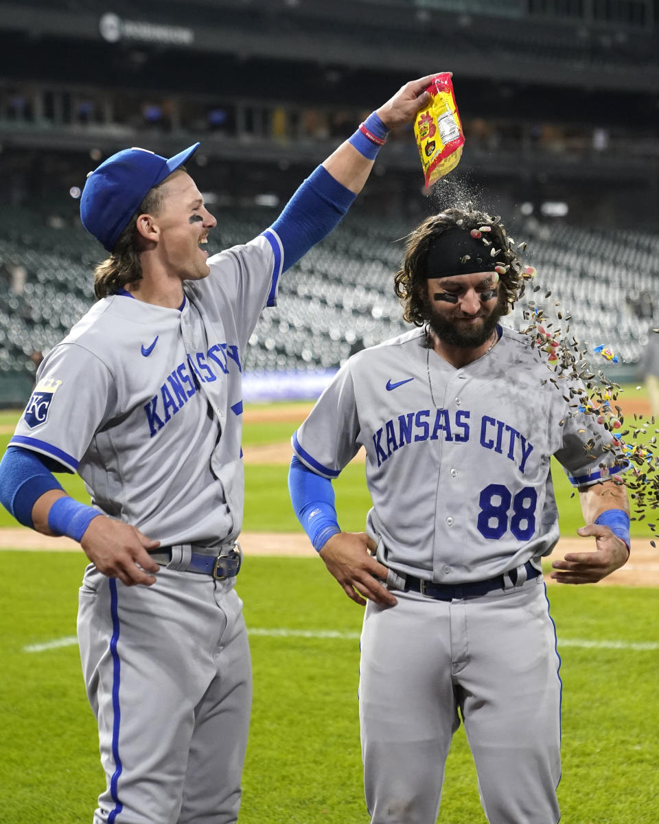 Kansas City Royals' Bobby Witt Jr., left, dumps sunflower seeds, bubble gum and candy onto catcher Logan Porter after the team's 11-10 win over the Chicago White Sox in the second game of a baseball doubleheader Tuesday, Sept. 12, 2023, in Chicago. (AP Photo/Charles Rex Arbogast)