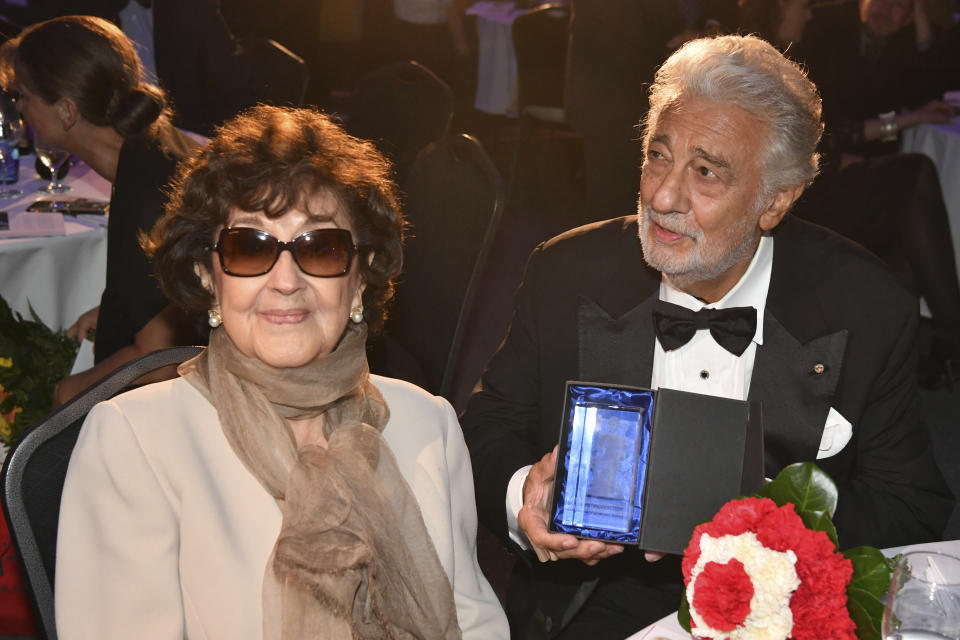 Opera tenor Placido Domingo, right, and his wife Marta sit at a table after he receives a lifetime award during Austria's Music Prize award at the Salzburg airport, Austria, Thursday, Aug. 6, 2020. (AP Photo/Kerstin Joensson)