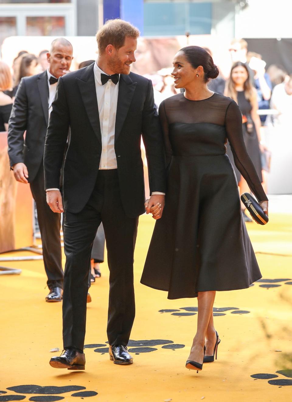 <p>Wearing matching black tie attire for the 'The Lion King' European premiere in London on 14 July, the Duke and Duchess of Sussex looked smitten as they walked the yellow-coloured carpet before meeting Beyoncé and Jay-Z. </p>