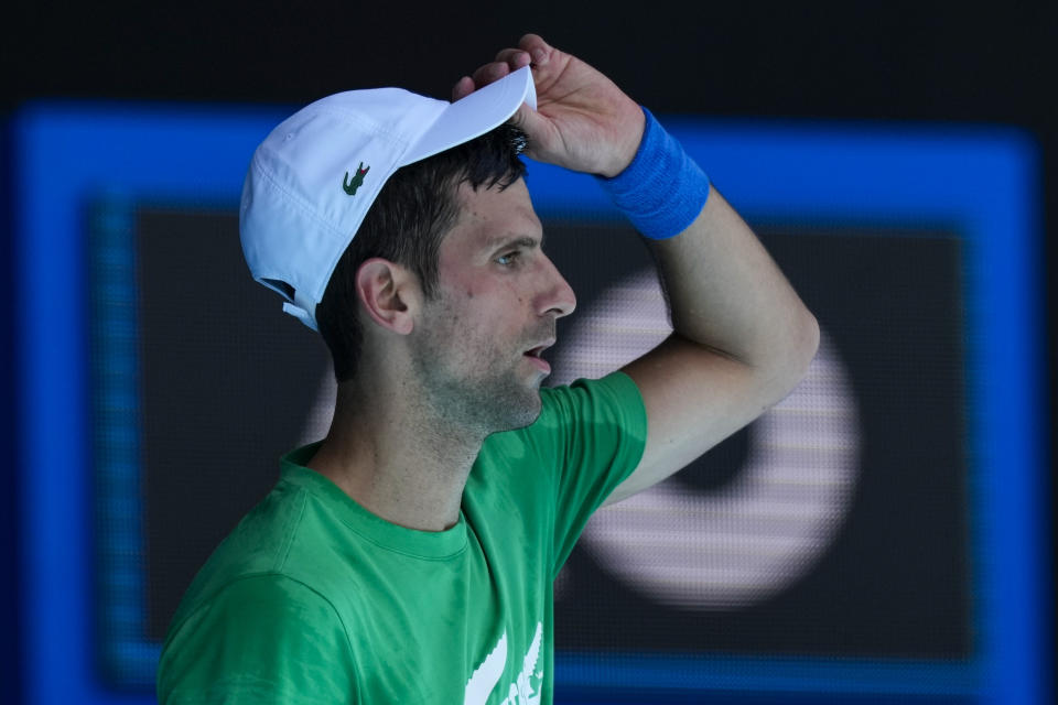 FILE - Defending men's champion Serbia's Novak Djokovic practices on Margaret Court Arena ahead of the Australian Open tennis championship in Melbourne, Australia, Jan. 13, 2022. Djokovic’s effort to play in the Australian Open despite being unvaccinated for COVID-19 moved to a higher court as the No. 1-ranked tennis player appealed the second cancellation of his visa. A judge scheduled another hearing for Sunday, Jan. 16. (AP Photo/Mark Baker, File)