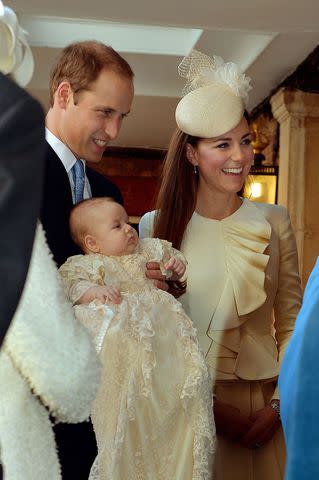 <p>John Stillwell - WPA Pool /Getty</p> Prince William, Kate Middleton and Prince George on his christening day at Chapel Royal in St James' Palace in October 2013.