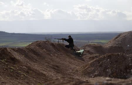 A rebel fighter from the Ahrar al-Sham Islamic Movement takes a position as he aims his weapon at Morek front line in the northern countryside of Hama March 16, 2015. REUTERS/Khalil Ashawi