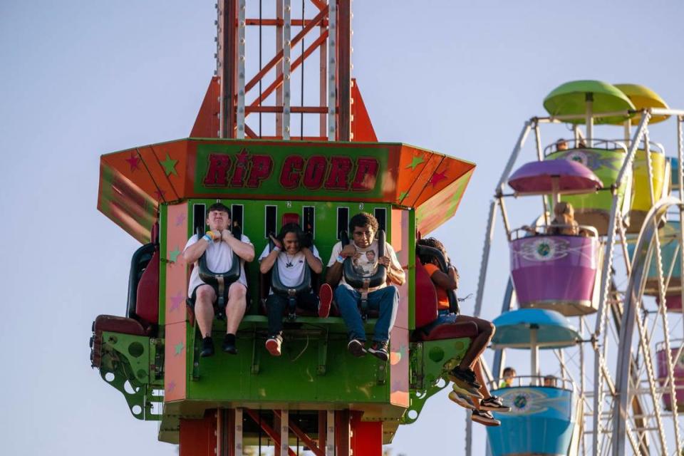 Rancho Cordova residents Brandon Walthof, Jonathan Alvarado and Isiah Lujan, all 18, react as they ride the Rip Cord at the city’s Fourth of July celebration on Wednesday at Hagan Park.