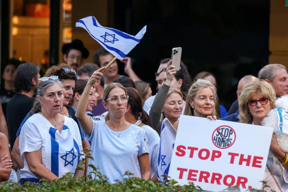 Attendees waved flags and held signs alongside members of the South Florida Jewish community and allies who gathered at the Waterways Shoppes in Aventura to support Israel in its war against Hamas on Monday, Oct. 9, 2023. Carl Juste/cjuste@miamiherald.com