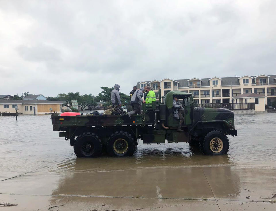 Hyde County officials, Sheriff Guire Cahoon and 3 deputies, and Hyde County Manager Kris Noble arrive at the fire company after having been helicoptered over, Friday, Sept. 6, 2019 on Ocracoke Island, N.C., in the aftermath of Hurricane Dorian. (Connie Leinbach/Ocracoke Observer via AP)