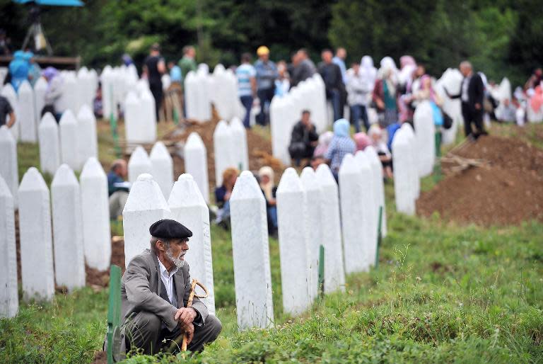 An elderly Bosnian Muslim man, survivor of the Srebrenica 1995 massacre, pays his respects at a relative's grave in the village of Potocari near the eastern-Bosnian town of Srebrenica, July 11, 2014