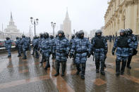 Riot police block an area protecting against demonstrators during a protest against the jailing of opposition leader Alexei Navalny in Moscow, Russia, Sunday, Jan. 31, 2021. Thousands of people took to the streets Sunday across Russia to demand the release of jailed opposition leader Alexei Navalny, keeping up the wave of nationwide protests that have rattled the Kremlin. Hundreds were detained by police. (AP Photo/Alexander Zemlianichenko)