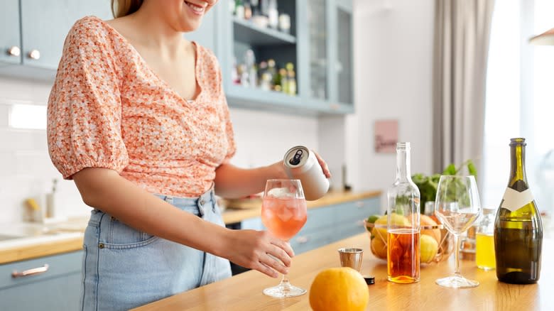 woman makes homemade cocktails