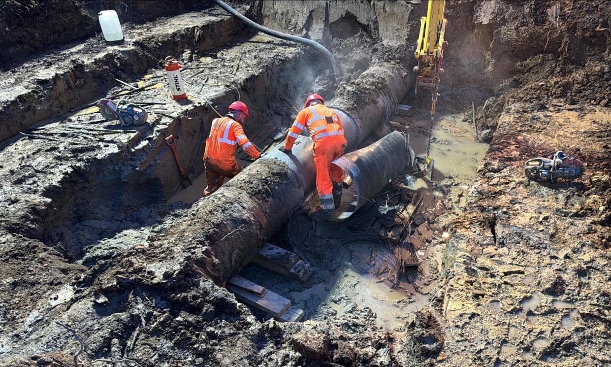 <span>Workers dig down to the burst pipe in Keeper’s Wood. Access to mains water should be fully restored over the course of Monday, Southern Water said.</span><span>Photograph: Southern Water</span>