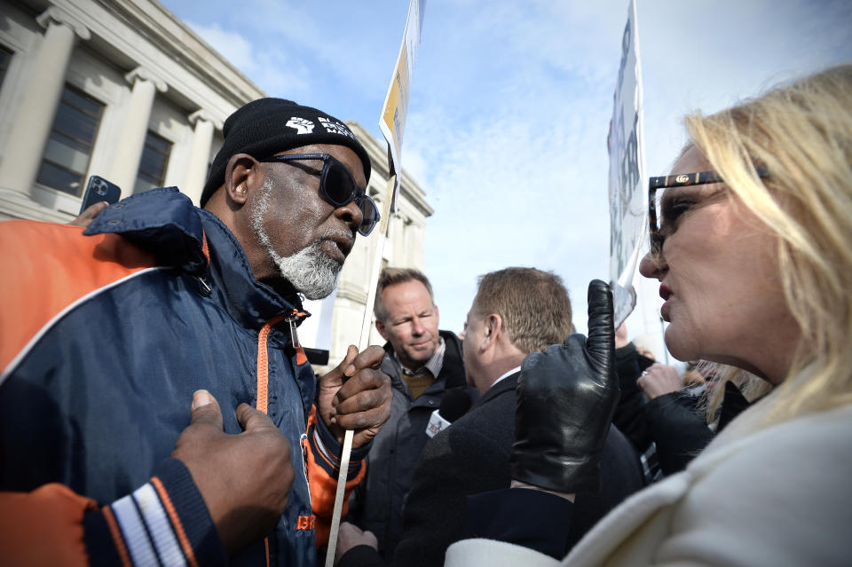 Clyde McLemore, founder of Black Lives Matter North Chicago Chapter, left, argues with Patricia McCloskey, right, as her husband, Mark, center, gives an interview in front of the Kenosha County Courthouse during Kyle Rittenhouse's trial in Kenosha, Wis. Tuesday, Nov. 16, 2021. Rittenhouse is accused of killing two people and wounding a third during a protest over police brutality in Kenosha, last year. (Sean Krajacic/The Kenosha News via AP)