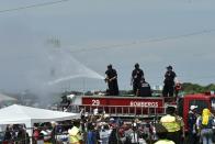 Firefighters spray water to cool off faithful waiting for the start of an open-air mass officiated by Pope Francis at Samanes Park in Guayaquil on July 6, 2015