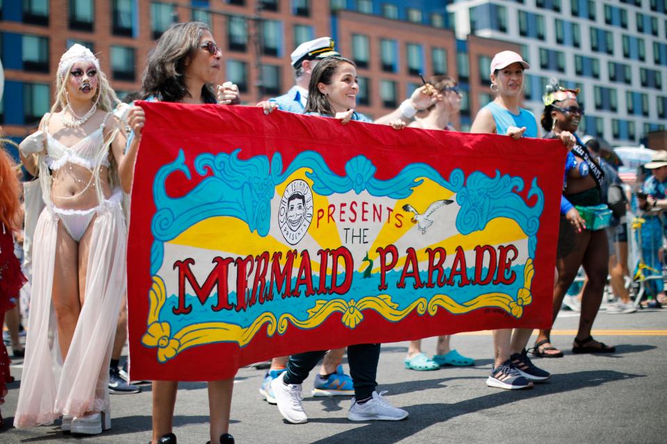 Parade marchers hold a banner during the Coney Island Mermaid Parade on June 22, 2024 in New York City.