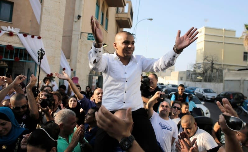 Groom Mahmoud Mansour, 26, celebrates with friends and family before his wedding to bride Maral Malka, 23, (not pictured) in Jaffa, south of Tel Aviv August 17, 2014. Israeli police on Sunday blocked more than 200 far-right Israeli protesters from rushing guests at the wedding of a Jewish woman and Muslim man as they shouted "death to the Arabs" in a sign of tensions stoked by the Gaza war. Picture taken August 17, 2014. To match MIDEAST-ISRAEL/WEDDING REUTERS/Ammar Awad