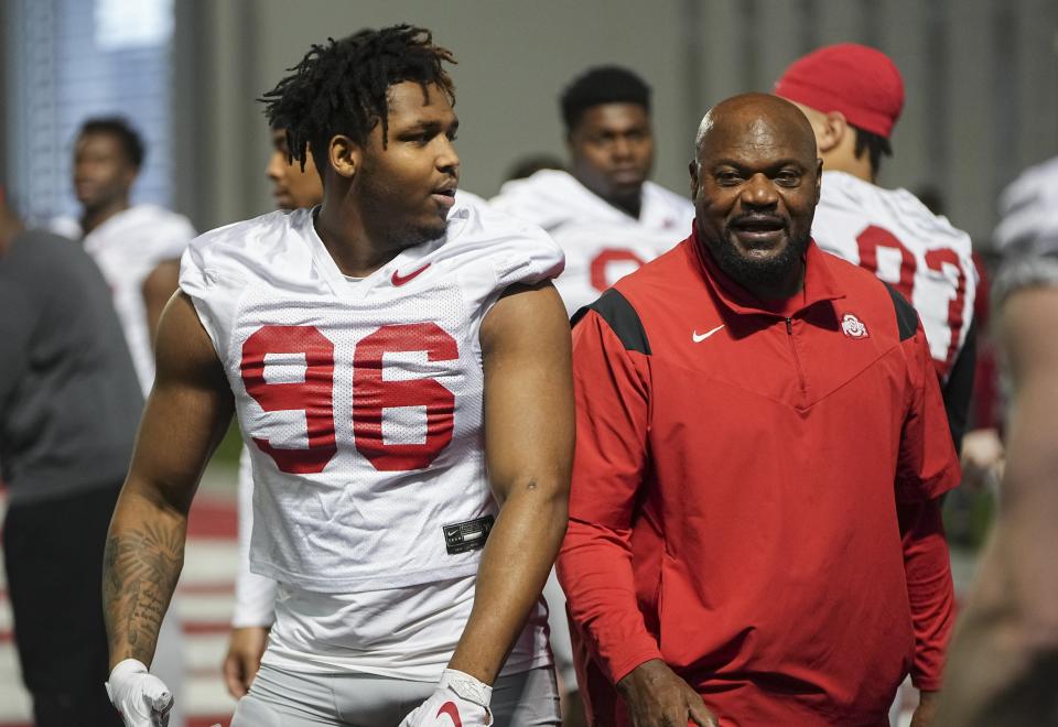 Mar 7, 2024; Columbus, OH, USA; Ohio State Buckeyes defensive end Eddrick Houston (96) works with defensive line coach Larry Johnson during spring football practice at the Woody Hayes Athletic Center.