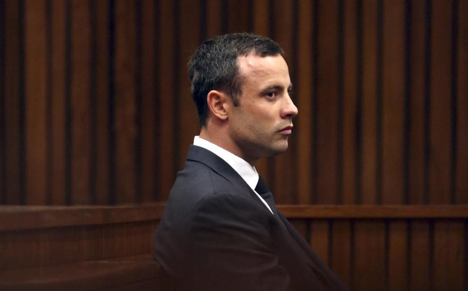 Oscar Pistorius, listens to cross questioning in court during his trial at the high court in Pretoria, South Africa, Friday, March 7, 2014. Pistorius is charged with murder for the shooting death of his girlfriend, Steenkamp, on Valentines Day in 2013. (AP Photo/Themba Hadebe, Pool)