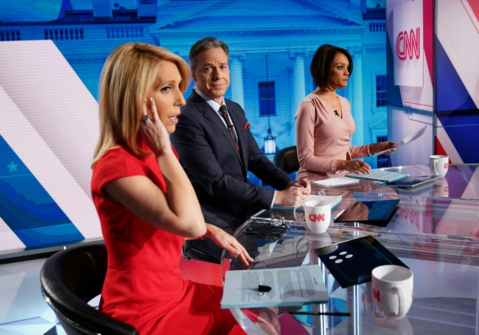 CNN news anchor Jake Tapper watches as co-anchor Dana Bash adjusts her ear piece before the start of the 11th Democratic Party 2020 presidential debate with former Vice-President Joe Biden and Vermont Senator Bernie Sanders in a CNN Washington Bureau studio in Washington, DC on March 15, 2020.