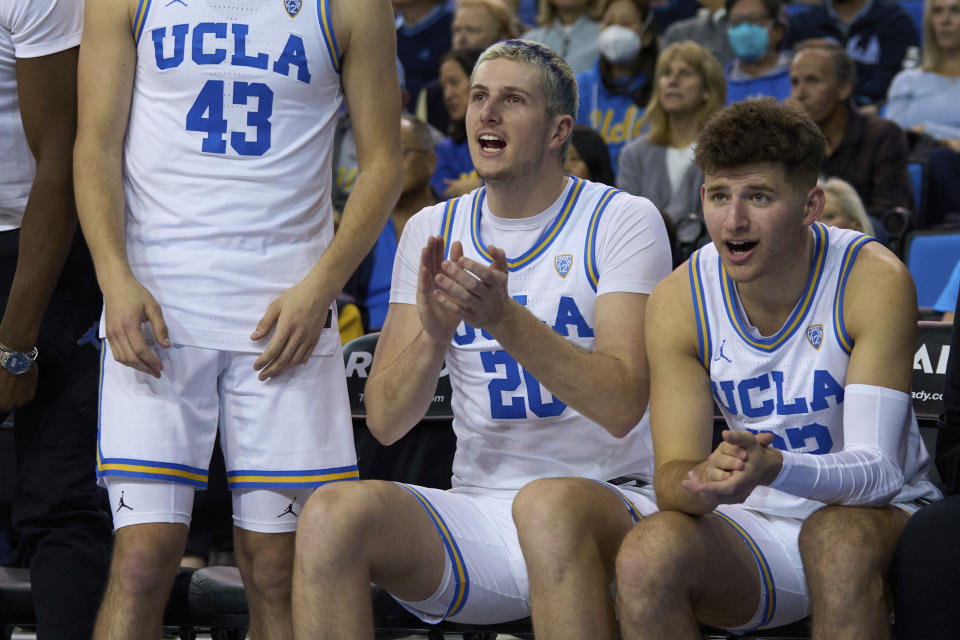 UCLA forward Logan Cremonesi and guard Jack Seidler react after a teammate's basket against California during the first half of an NCAA college basketball game Saturday, Feb. 18, 2023, in Los Angeles. (AP Photo/Allison Dinner)