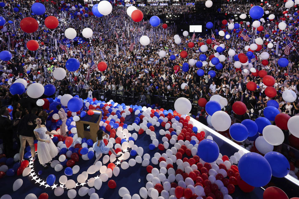 Democratic presidential nominee Vice President Kamala Harris' stepdaughter Ella Emhoff and Harris' great-niece Leela, play with balloons on Day 4 of the Democratic National Convention, Thursday night, Aug. 23, 2024, at the United Center in Chicago. (Mike Segar/Pool via AP)