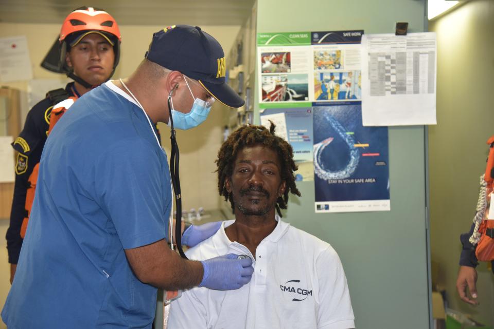 In this photo provided by Colombia's Navy press office, castaway Elvis Francois is attended by Colombian Navy members after he was rescued near the department of La Guajira, in the extreme north of Colombia, as he sits on board the merchant ship CMA CGM Voltario at the port of Cartagena, Colombia, Monday, Jan. 16, 2023. According to the Navy, the 47-year-old from Dominica said he had been adrift for 24 days in the Caribbean Sea after he was repairing a boat last December near the island of Sint-Maarten in the Netherlands Antilles.