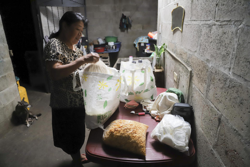 María Concepción Ventura prepares a care package to deliver to her imprisoned daughter Juana Guadalupe Recinos, a single mother of two boys, in Santa Ana, El Salvador, Wednesday, Jan. 31, 2024. When Recinos was detained outside their home last June during the government's crackdown on its war against drugs, her mother was left reeling, with two more mouths to feed and struggling to pay the bills without her daughter’s salary. (AP Photo/Salvador Melendez)