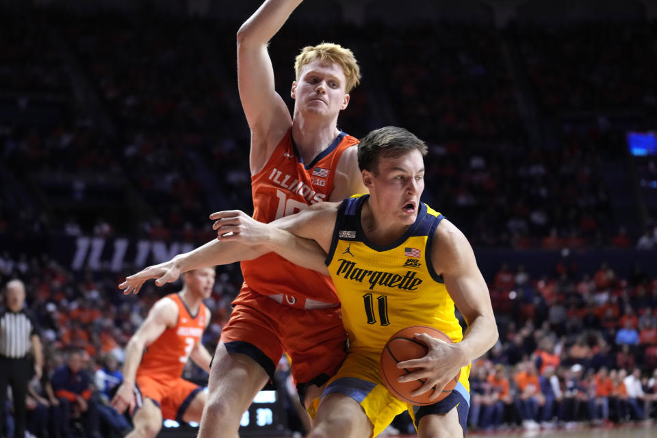 Marquette guard Tyler Kolek (11) spins away from Illinois guard Luke Goode during the second half of an NCAA college basketball game Tuesday, Nov. 14, 2023, in Champaign, Ill. (AP Photo/Charles Rex Arbogast)