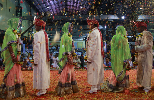 <p>Underprivileged and specially abled couples take part in a mass wedding where 51 couples got married in Mumbai, India, Sunday, May 29, 2016. Mass weddings in India are organized by social organizations primarily to help the economically challenged families who cannot afford the high ceremony costs as well as the customary dowry and expensive gifts that are still prevalent in many communities. <em>(AP Photo/Rafiq Maqbool)</em> </p>