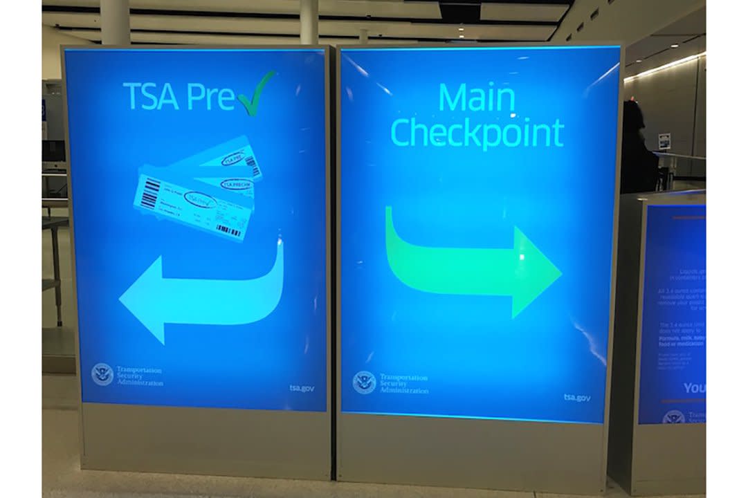 Sign for regular boarding and TSA Precheck at the airport