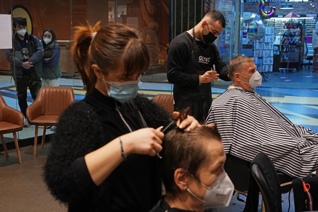 A hairstylist cuts hair at a barbershop and hair salon on the first day it reopened since a hard lockdown went into effect last December during the coronavirus pandemic on March 1, 2021, in Berlin, Germany.