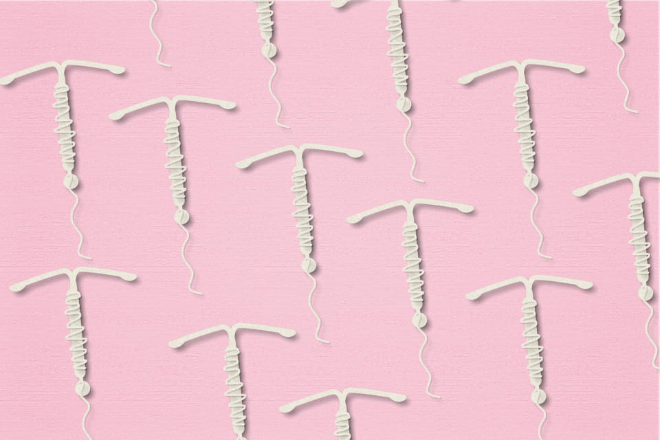 A concept photo of several IUDs on top of a pink background. (Photo via Getty Images)