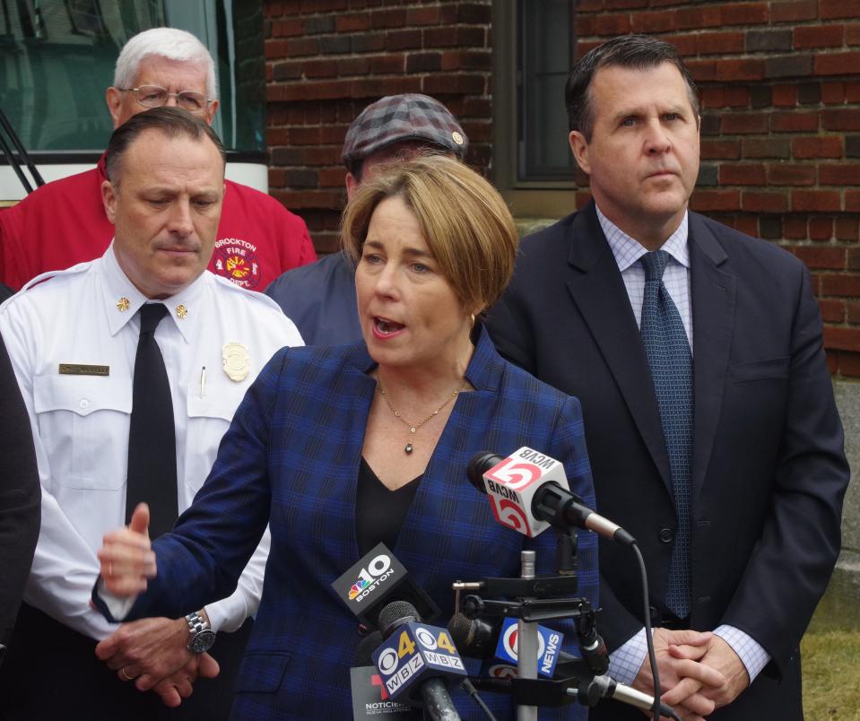 Gov. Maura Healey answers a reporter's question at a press conference outside Brockton Fire Station 1 on Pleasant Street in Brockton on Thursday, March 2, 2023. To the left is Fire Chief Brian Nardelli and to the right is Mayor Robert Sullivan.