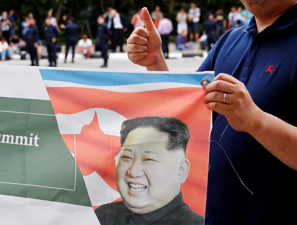 <p>A South Korean man flashes a thumbs-up as he holds up a banner in support of the summit between President Donald Trump and North Korea’s leader Kim Jong Un, near the Capella hotel on Sentosa island in Singapore June 12, 2018. (Photo: Kim Kyung-hoon/Reuters) </p>