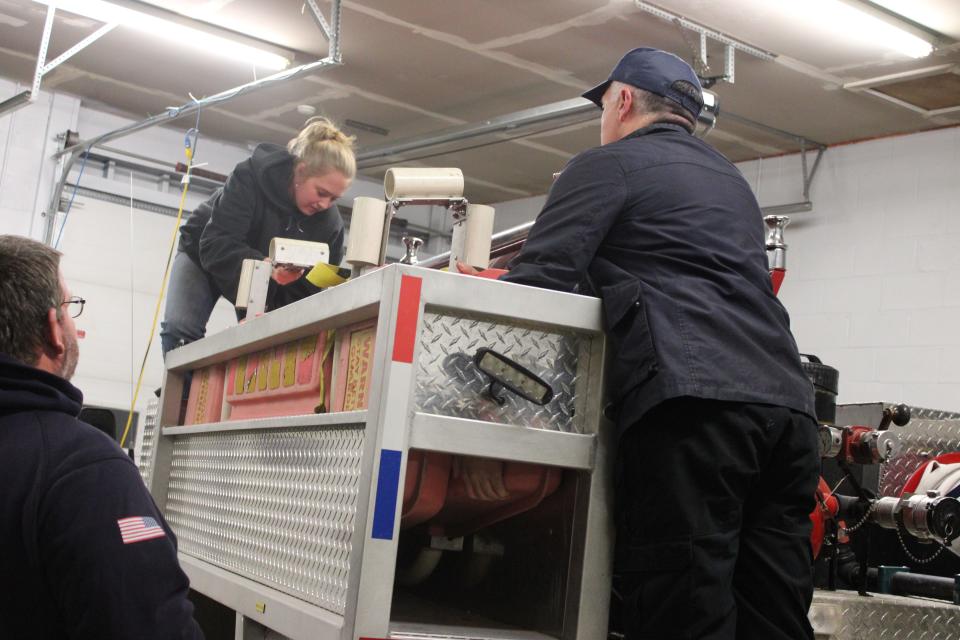 At a training at the Petersham Fire Department, Quabbin senior Hannah Baxter helps load equipment onto the truck. Baxter has participated in the junior firefighter program since she was a freshman.